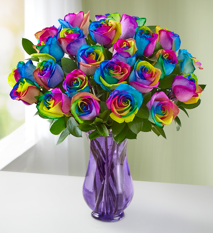 A purple vase filled with rainbow kaleidoscope roses from 1-800-Flowers.com