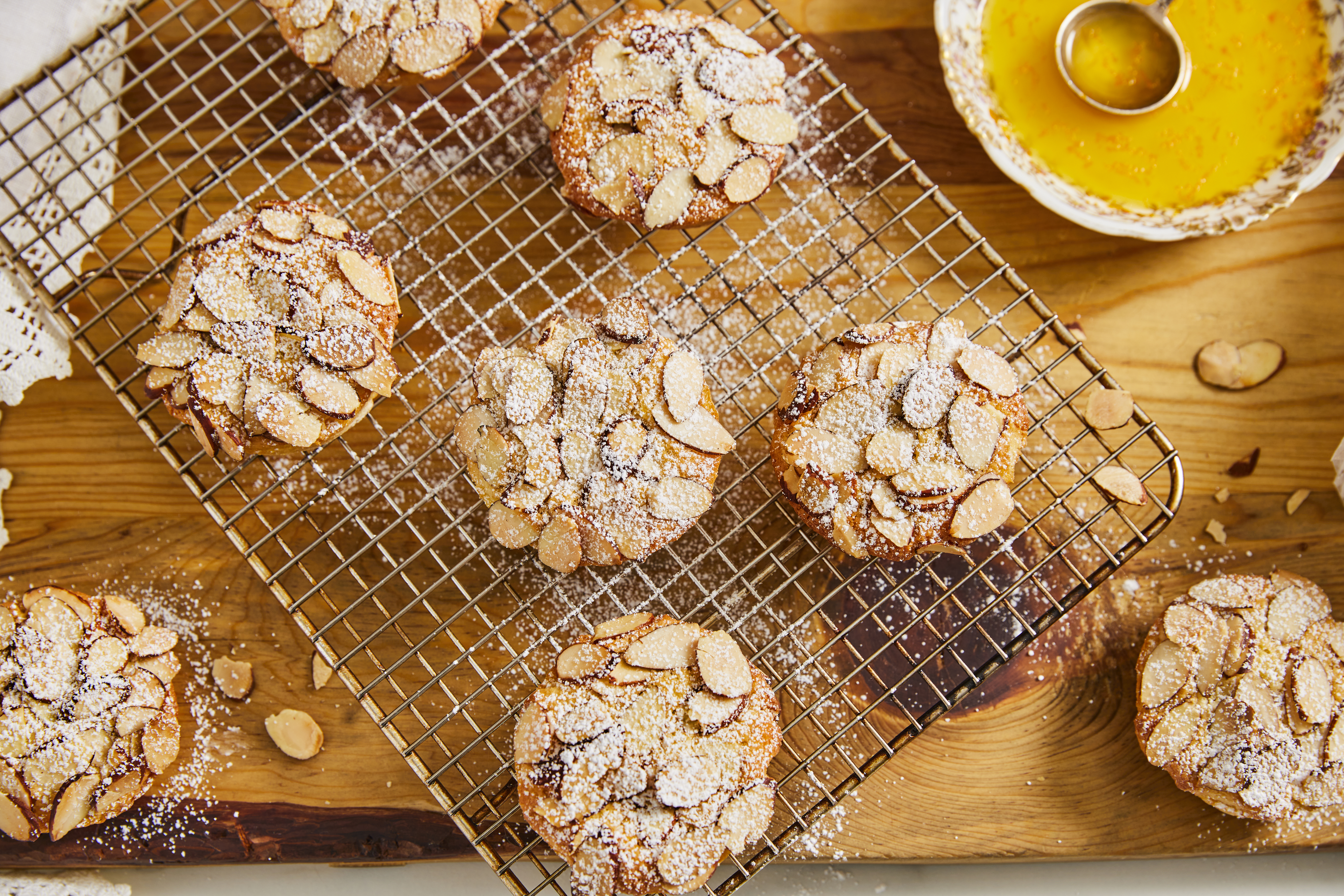 A tray of powdered Mini Citrus Bostock Bites on a wooden table