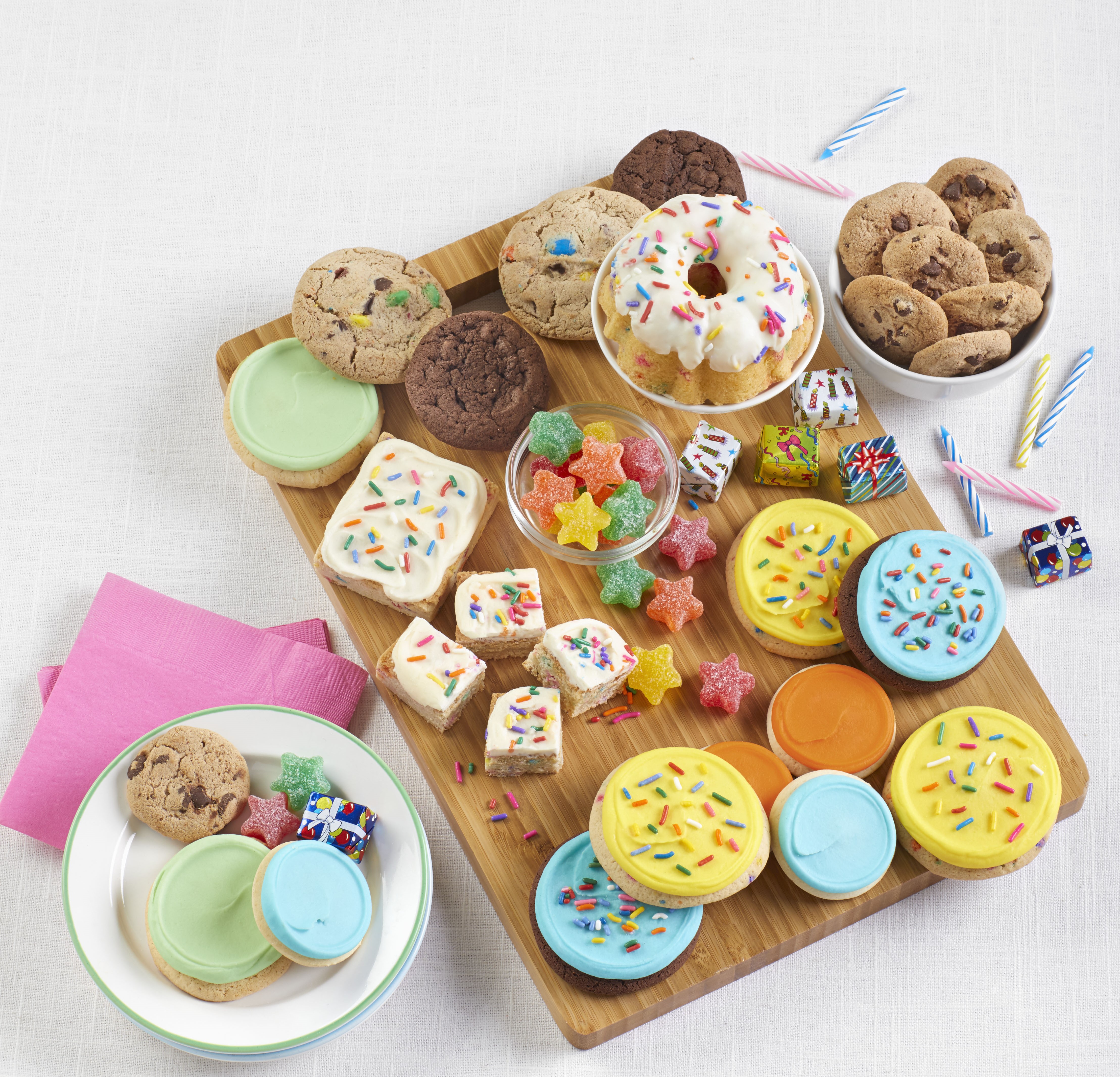 A charcuterie board with cookies, brownies, buttercream frosted cookies, and other treats from Cheryl's Cookies