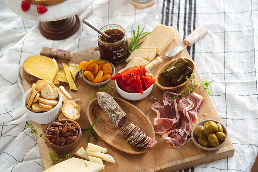 A charcuterie board of cured meats, cheeses, dried fruit, olives, and spreads from Harry and David