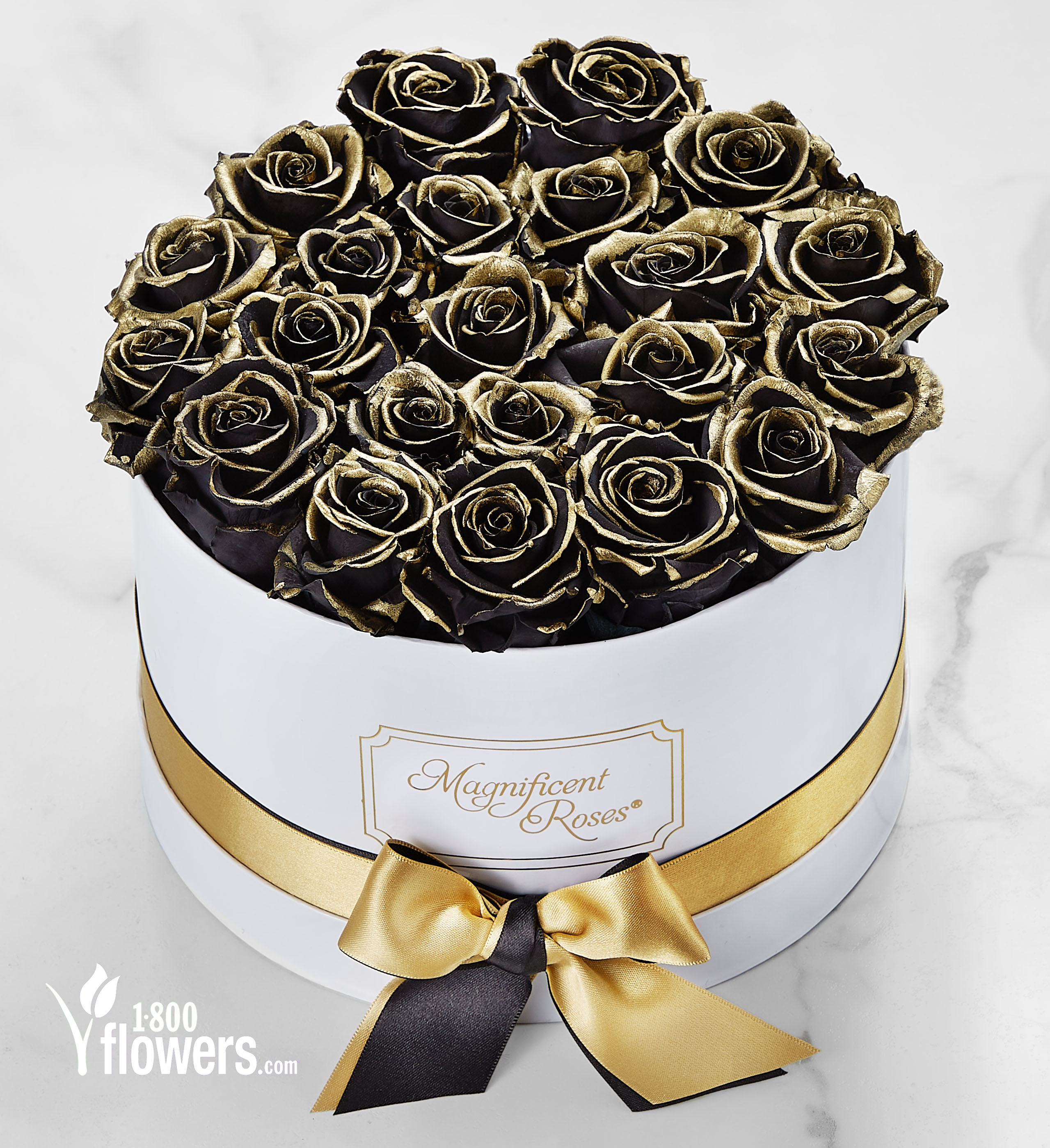 A display of preserved black roses with gold on the edges of the petals, from the 1-800-Flowers.com Magnificent Roses collection