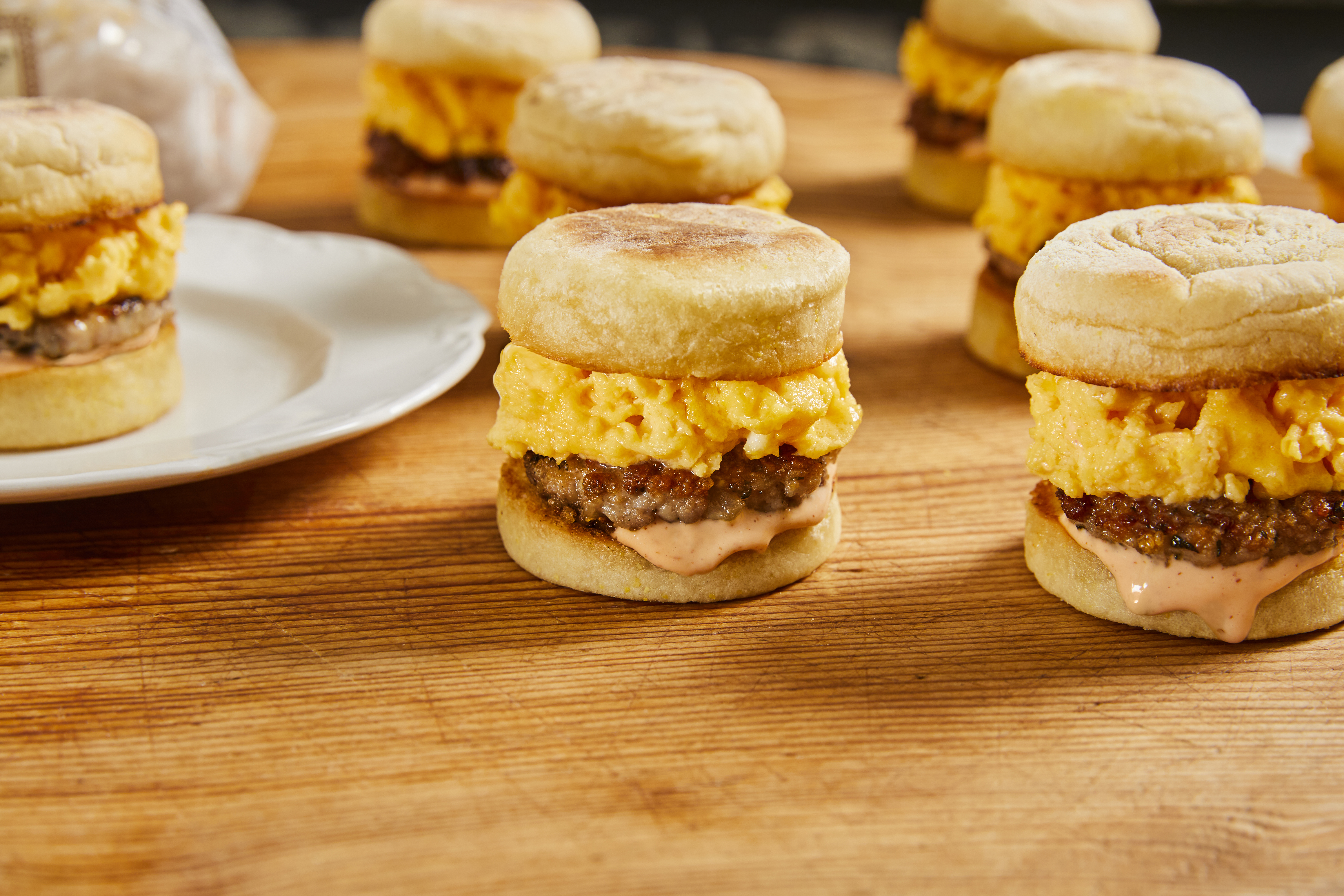 A display of Mini Brekkie Sandies with eggs and sausage on Wolferman's Bakery Mini English Muffins