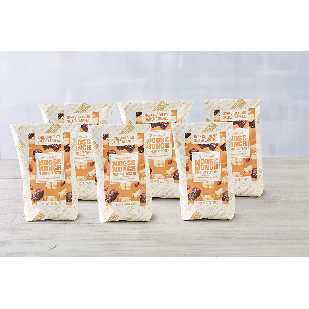 A 6-Pack of the salted caramel Moose Munch standing upright on a table