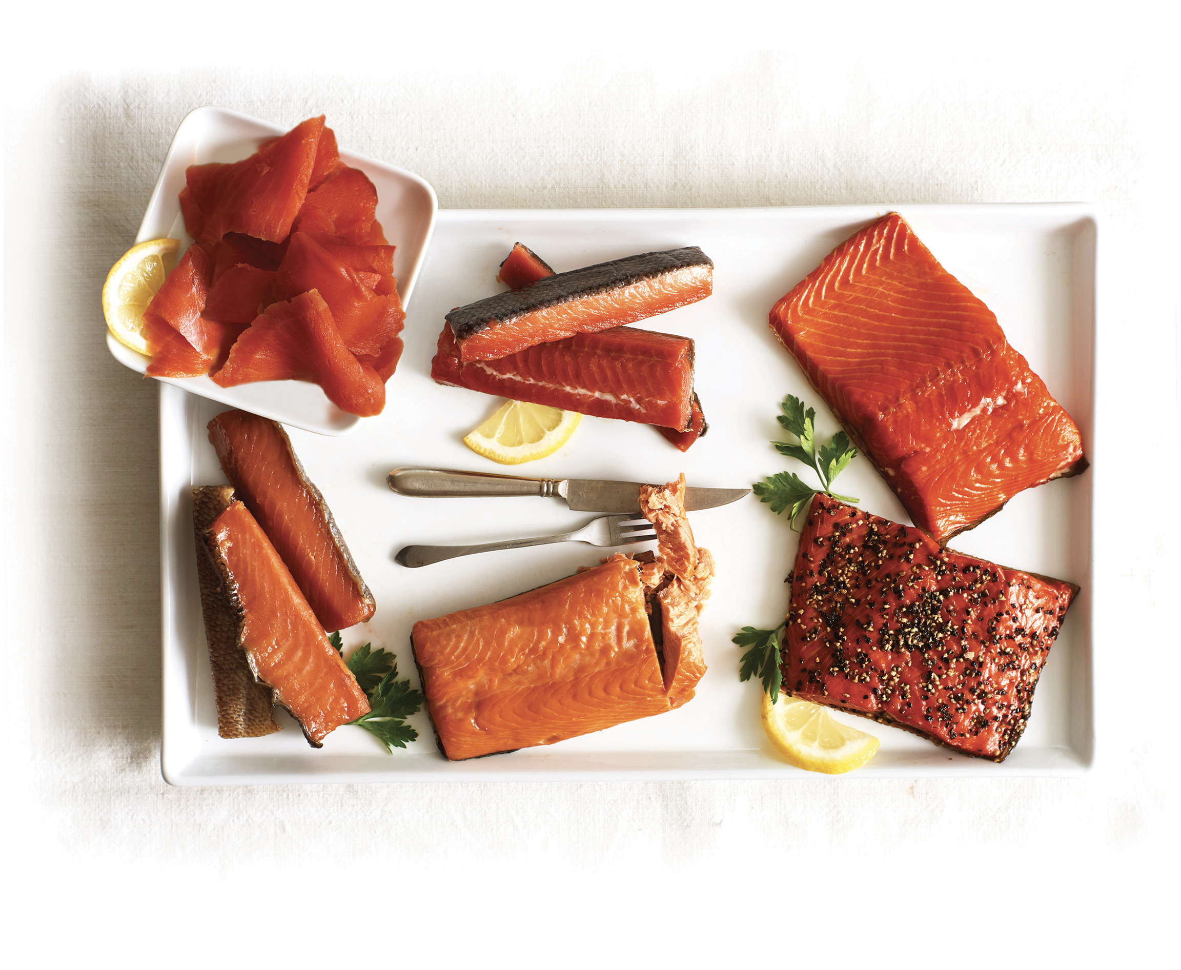 A platter salmon from Vital Choice garnished with lemon and herbs