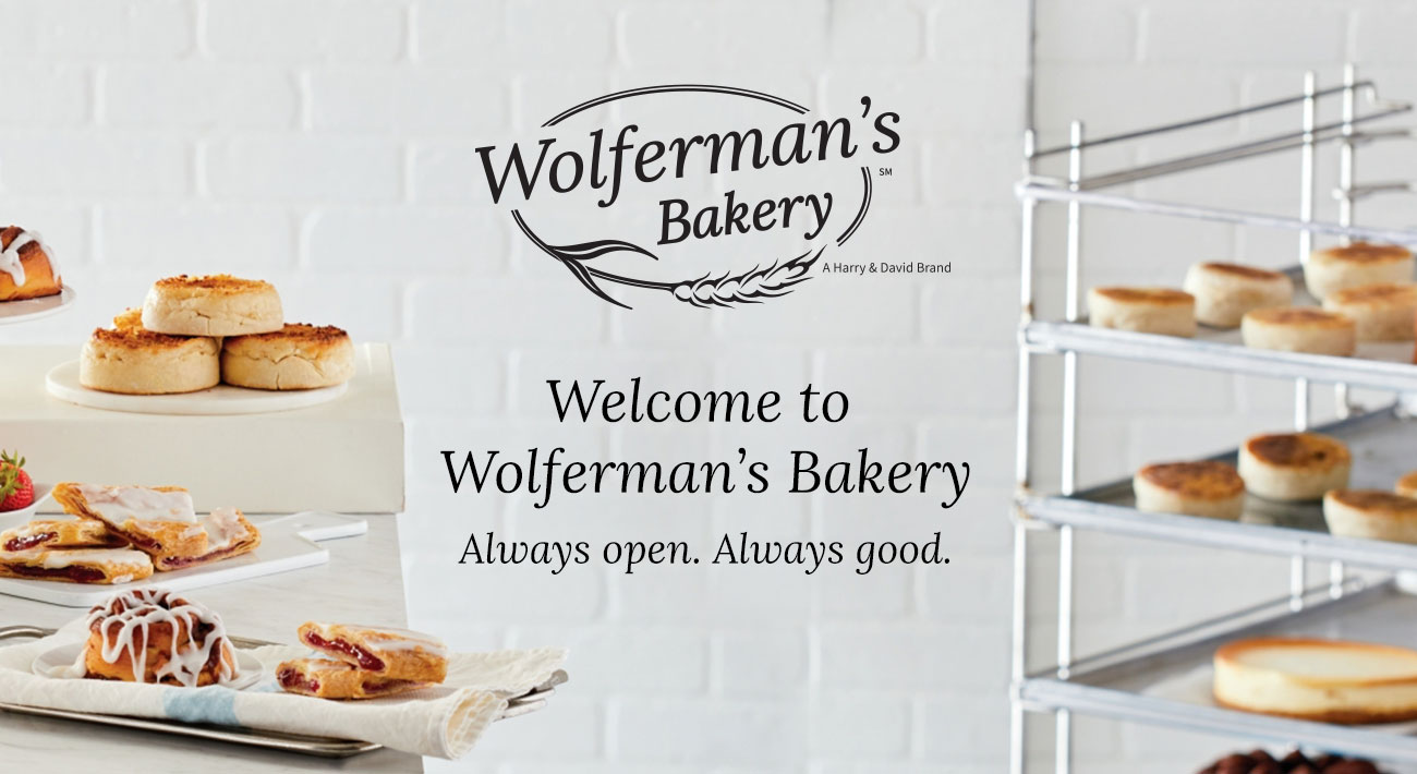 The Wolferman's Bakery logo in the middle of a table and a rolling tray of products from the brand