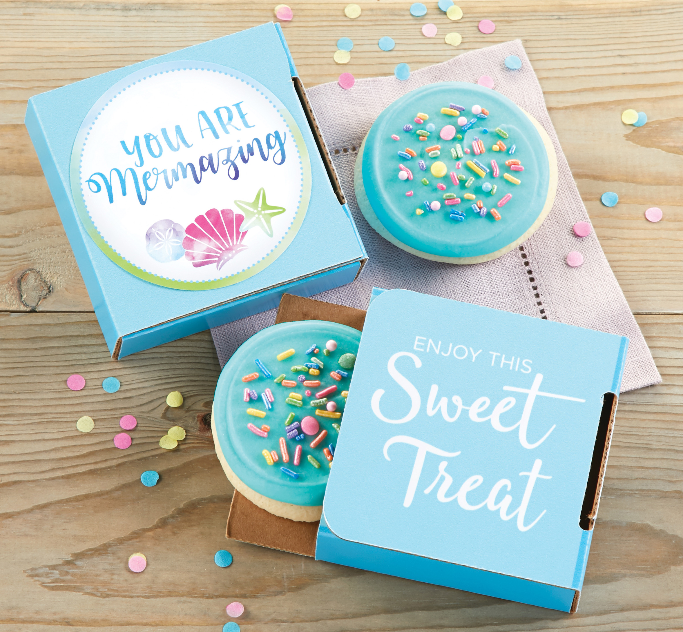 Two cookie cards from Cheryl's Cookies with blue iced cookies individually packaged in small blue boxes that say You Are Mermazing and Enjoy This Sweet Treat