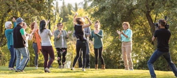 A group of people formed in a circle dancing
