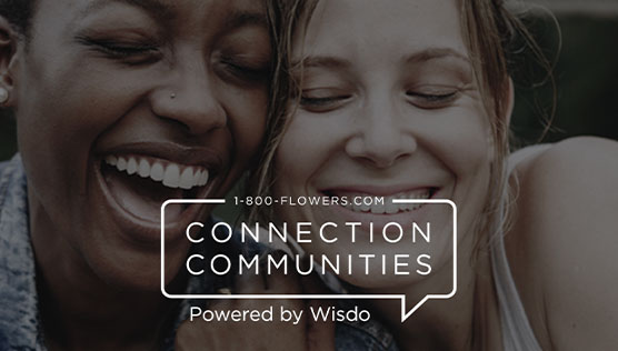 Two women smiling behind the 1-800-Flowers.com Connection Communities logo